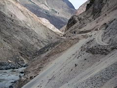 08 Road Though Braldu Gorge To Askole Slants Dangerously Towards The Roaring Braldu River On our seven-hour 117km jeep ride from Skardu to the trailhead at Thongol (2850m), we drove through the 40km Braldu Gorge, where the road is blasted out of the rocks next to the roaring Braldu River. The sickeningly narrow gravel road sometimes slants dangerously towards the Braldu River. You have to withstand being scared constantly for two hours with your life clearly in your drivers eyes, hands and feet. 'Oh well', I thought. The scariest thing for me was when the jeep had to do three-point turns around hairpin curves. He'd get to the edge with the foaming Braldu River hundreds of metres below, and then reverse back up the hill. 'I hope he knows the reverse gear', I think to myself.